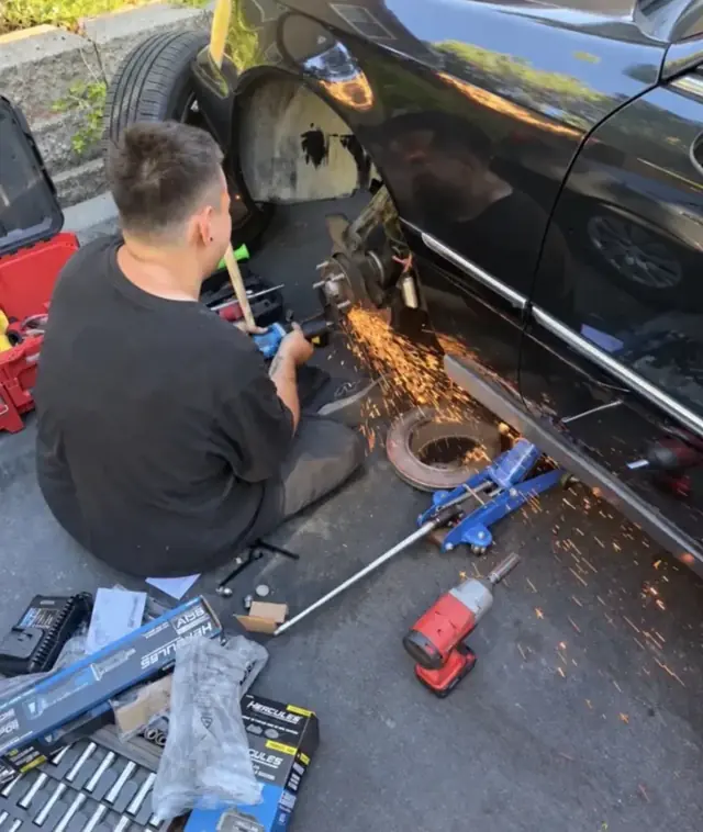 Ethan on a brake job in a customer's driveway